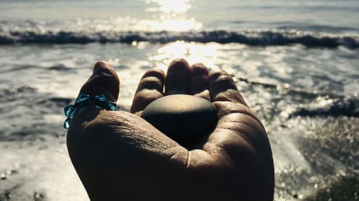 photo of hand holding a stone